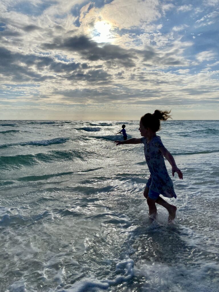 Young girl playing in the waves